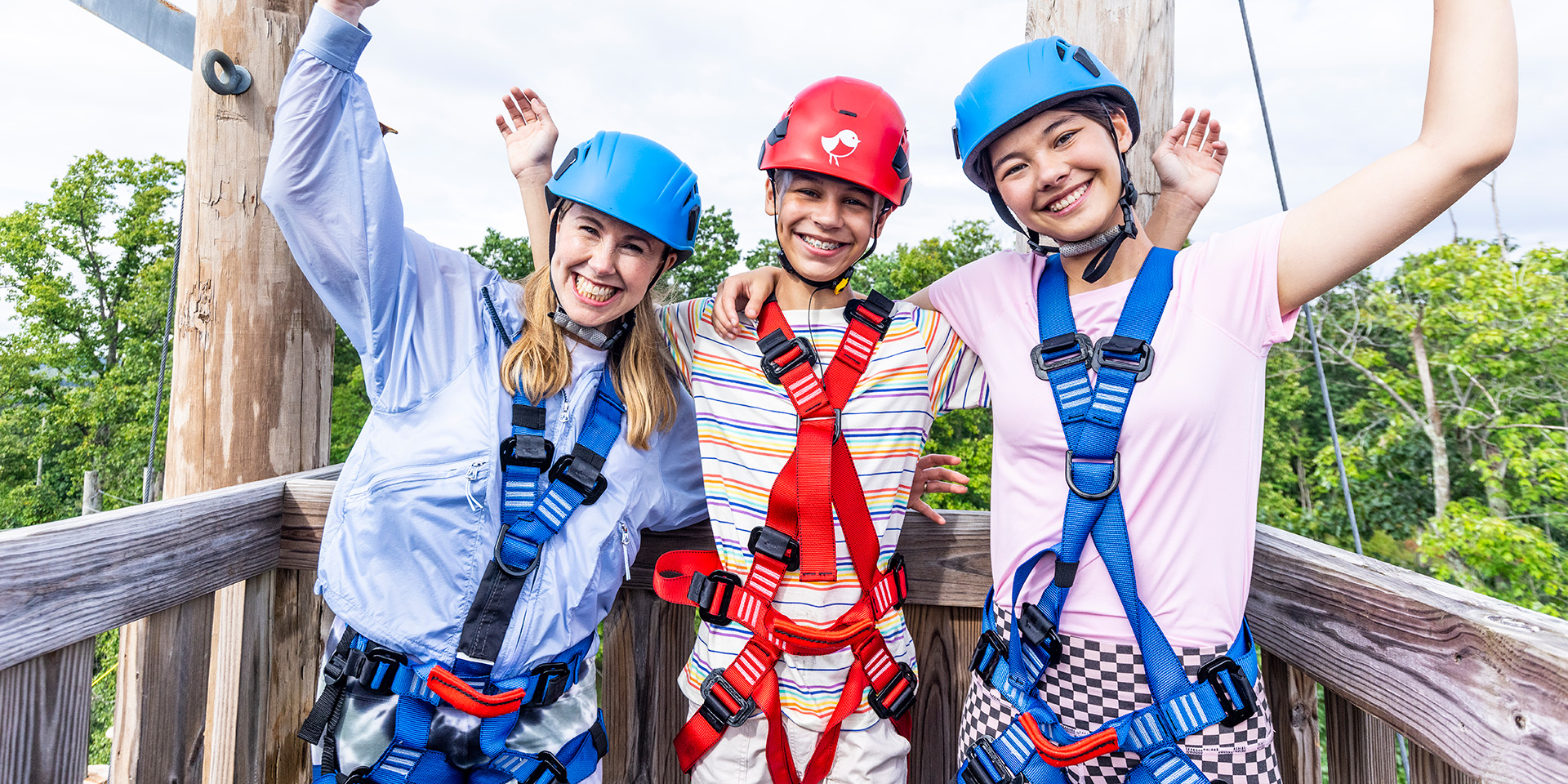 three people on a ropes course